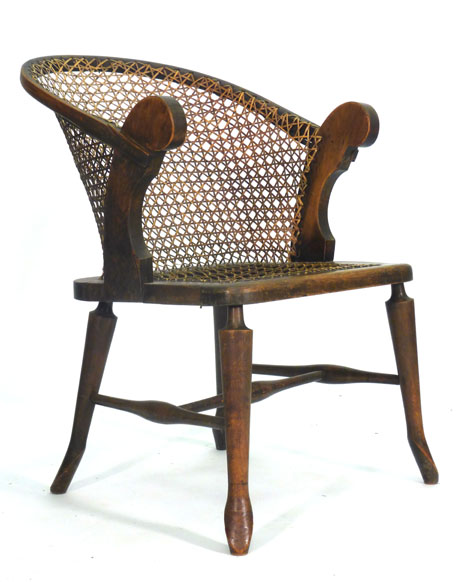 A Victorian beech and bergere armchair CONDITION REPORT: Heavy wear but structurally sound