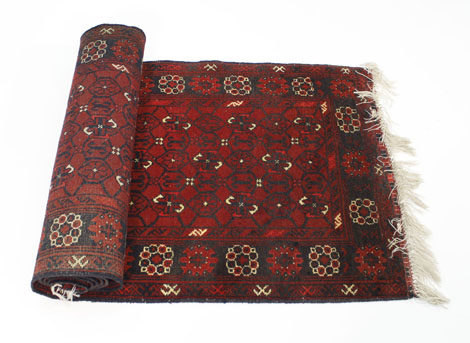 A Turkoman-style runner of Tekke design, the red ground within a matching border, 300 x 80 cm