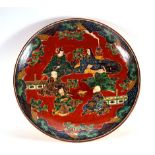 A Kutani charger centrally painted with a scene depicting six figures creating a poem, d. 36.5 cm,