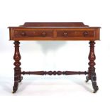 A Victorian walnut writing table with two frieze drawers on turned supports with scrolled feet, w.