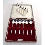 A silver four slice toast rack of arch shaped form and a cased set of six seal end coffee spoons,