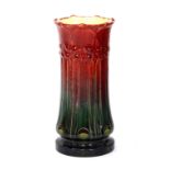 A Burmantofts Faience jardiniere stand/stick stand of Art Nouveau design decorated in a plain red