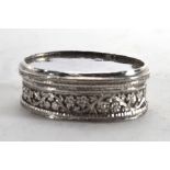 An Anglo Indian metalware lidded container of oval form with foliate border, unmarked, w. 6.5 cm