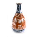 A Japanese spill vase of slender ovoid form typically decorated with figures in the Imari palette,