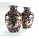 A pair of early 20th century Japanese vases of baluster form typically decorated in the Imari