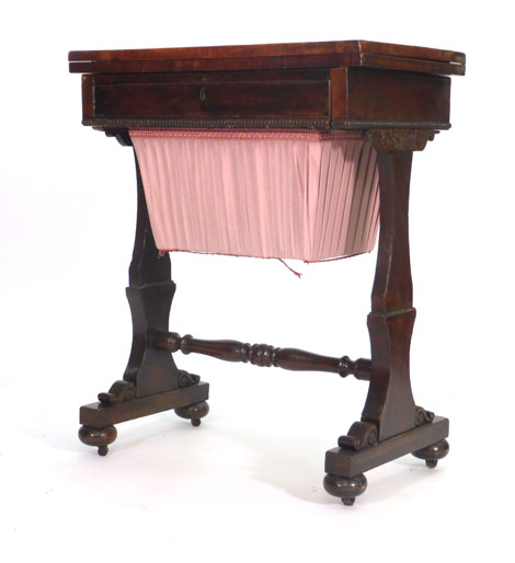 A Victorian mahogany work table, the fold over top above a frieze drawer and a suspended basket on