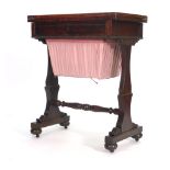 A Victorian mahogany work table, the fold over top above a frieze drawer and a suspended basket on