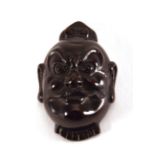 A carved hardwood netsuke modelled as a male figure, l. 5.4 cm, signed with bone insert verso