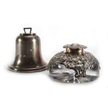 A silver inkwell in the form of a bell, h. 8 cm and a silver overlaid glass inkwell of squat form,