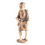 A Japanese carved ivory figure in the form of a travelling gentleman, h. 16 cm, signed to base