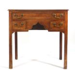 An 18th century fruitwood lowboy, the shaped apron with one long and two short drawers, on square