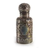 A Victorian silver florally decorated scent bottle of cylindrical form, hallmarks indistinct, h. 8.5
