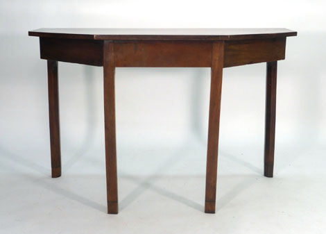 A George III mahogany D-end dining table of canted form with central drop-leaf section and an