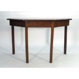 A George III mahogany D-end dining table of canted form with central drop-leaf section and an