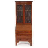 An Edwardian mahogany and inlaid bureau bookcase, the astral glazed doors over a fall front and