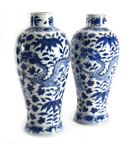 A pair of 19th Chinese century blue and white vases of slender baluster form decorated with dragons,