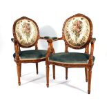 A pair of Louis XV-style walnut and part upholstered parlour armchairs by Epstein CONDITION