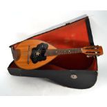 A cased Czechoslovakian eight string mandolin with inlaid face, l. 60 cm CONDITION REPORT: Three