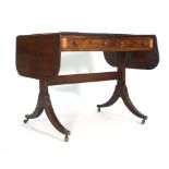 An early 19th century mahogany and strung sofa table with two frieze drawers on two supports with