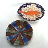 A 19th century Japanese oval dish centrally decorated with two carp in the Imari palette, w. 31 cm