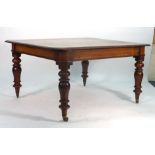 A 19th century mahogany extending dining table, with three fitted leaves, on turned legs with