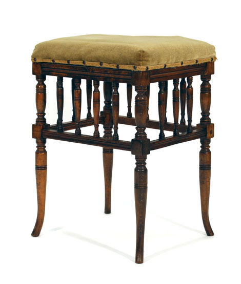 A stained beech stool, the raised seat above a series of spindles on turned supports CONDITION