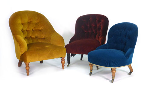 A Victorian button upholstered fireside armchair on mahogany turned feet, together with two other