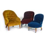 A Victorian button upholstered fireside armchair on mahogany turned feet, together with two other