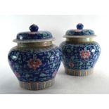 A pair of Cantonese vases and covers of squat baluster form, each decorated with chrysanthemum on an