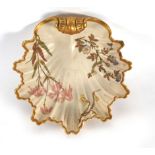 A Royal Worcester dish of leaf shaped form, typically gilt decorated with floral sprays on a blush