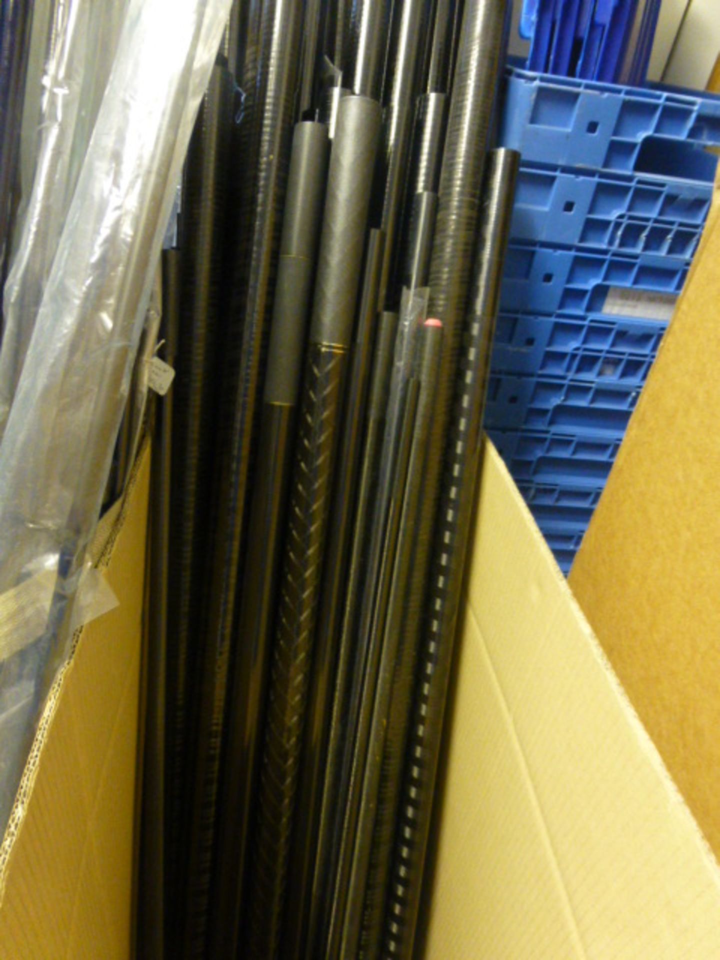 A large box of carp poles and parts including various rod tubes