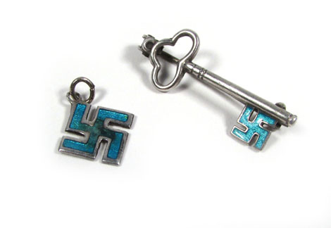 A Charles Horner silver pendant in the form of a swastika and decorated in turquoise enamel, Chester