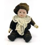 A bisque headed baby doll with fixed brown glass eyes and painted features, h. 44 cm