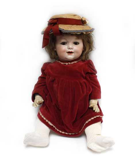 An Armand Marseille bisque headed doll with sleeping brown glass eyes, painted features and open