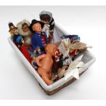 A Ma-Sit collapsible dolls pram in pink gingham containing a small group of national dolls and