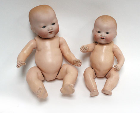 An Armand Marseille 'Dream Baby' doll, head stamped '351/3K', h. 29 cm and another, smaller head