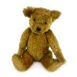 A mid 20th century English fully jointed bear in golden mohair with amber/black eyes, shaved muzzle,