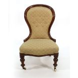 A Victorian mahogany and button upholstered nursing chair on turned legs with castors CONDITION