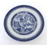 A 19th century Chinese blue and white charger, typically decorated with figures in a townscape, d.