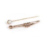 A 9ct yellow gold bar brooch of serpent design and a Swedish yellow gold stick pin set single pearl,