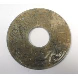 A carved mottled green jade bi-disc of archaic form, d.