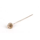 A 19th century yellow metal stick pin set centrally with a single rose cut diamond in a black