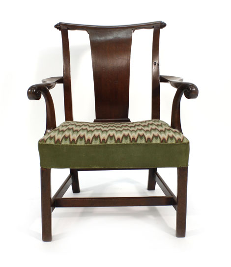 A George III mahogany and upholstered open armchair on square straight legs joined by stretchers