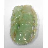 A carved pale green jade pendant depicting a monkey climbing bamboo, l.