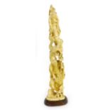 A Japanese ivory figural group of tusk shaped form modelled as two sage and a dragon, h. 34.5 cm,