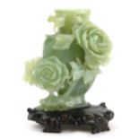 A Chinese carved jade ornamental vase and cover encrusted with chrysanthemums, celadon green,