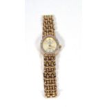 A 9ct yellow gold ladies wristwatch by Sovereign, the oval dial with gold coloured baton numerals