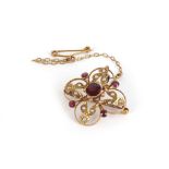 An Edwardian 9ct yellow gold openwork pendant/brooch set garnets and seed pearls, l. 2.7 cm, 3.