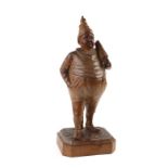 A late 19th/early 20th century continental carved boxwood tobacco jar in the form of a man at