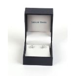A pair of 18ct white gold stud earrings, each set a single diamond, stones approx. 0.